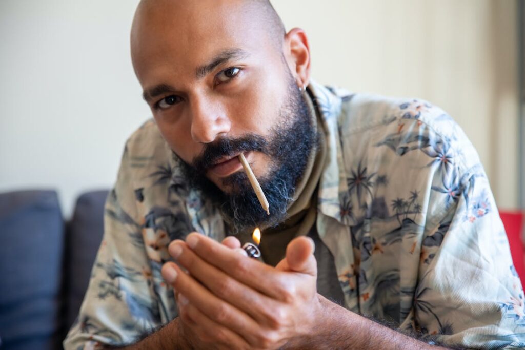 Man lighting a marijuana joint