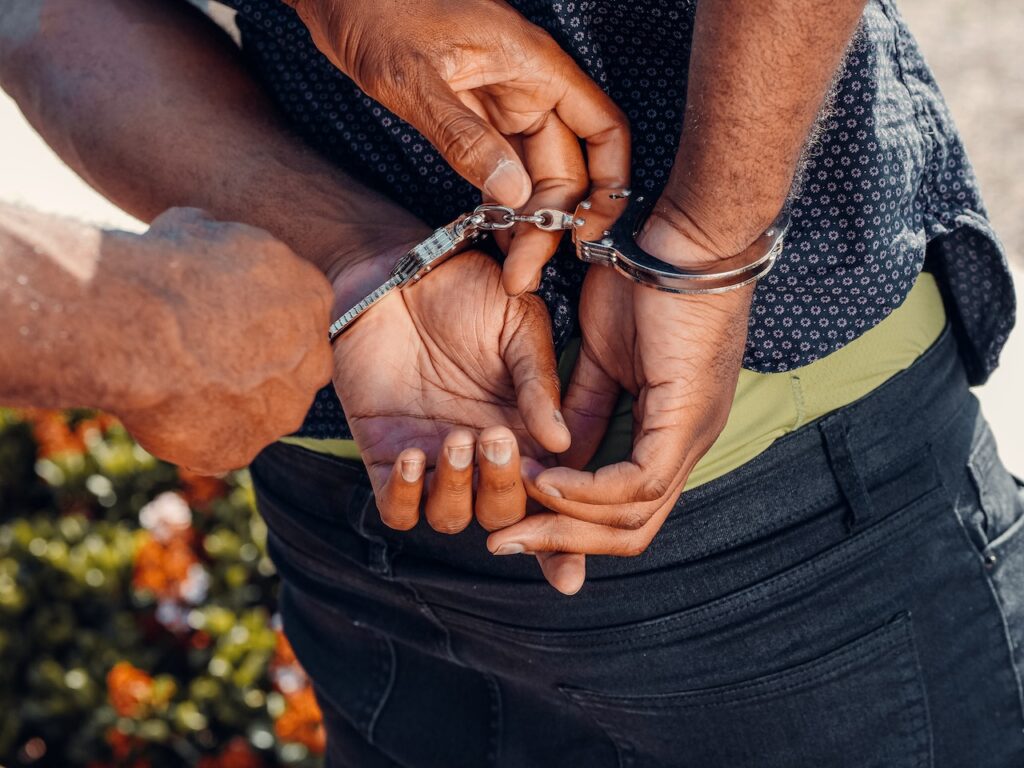 Person of color being handcuffed