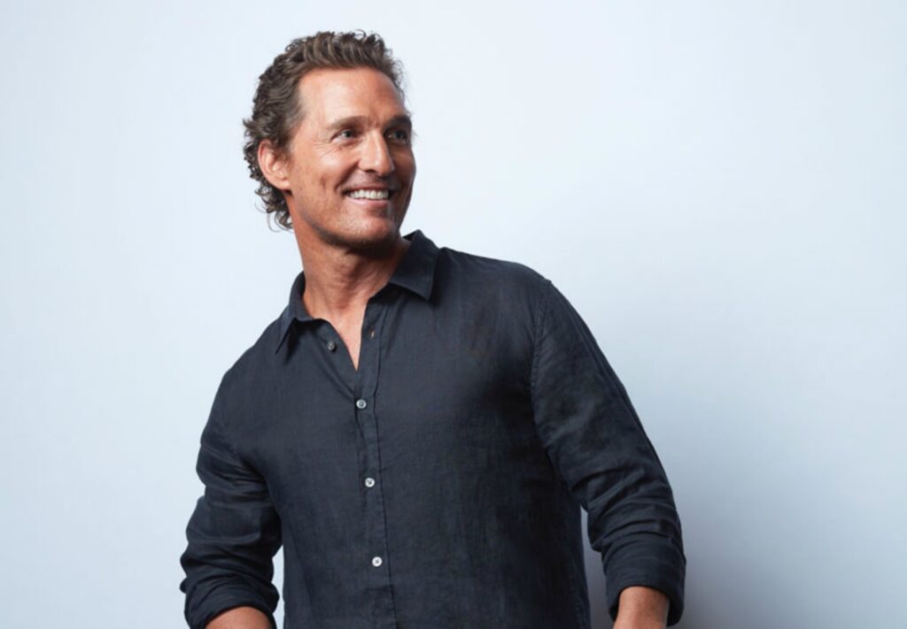 Matthew McConaughey smiling in black shirt