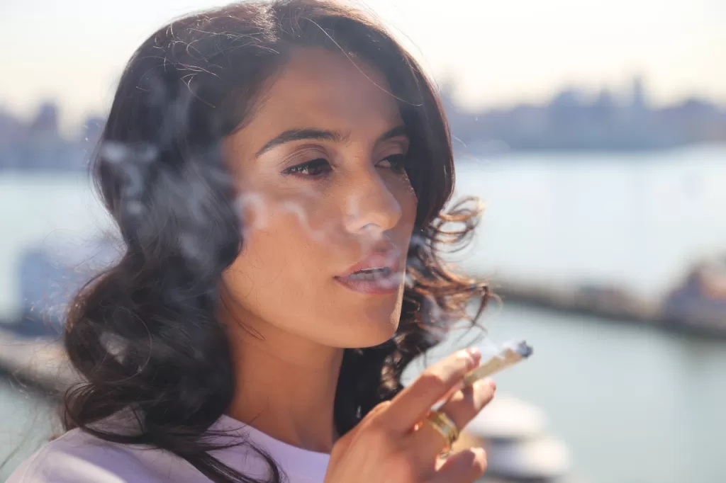 Woman smoking some LA Confidential strain